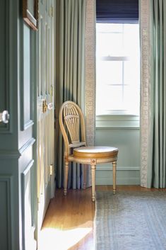 a chair sitting next to a window in a room