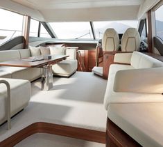 the inside of a boat with couches and tables