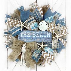 a wreath made out of burlocks and beach decorations