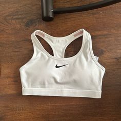 Not Worn. White Nike Sports Bra Nike Go-dry Sports Bra For Light Sports, Nike Sportswear For Sports Events, Nike Sporty Activewear For Sports Events, Nike Sporty Sports Bra For Light Sports, Nike Sporty Sports Bra For Light Activities, White Sweat-resistant Sports Bra, Nike White Sports Bra For Sports Events, Nike White Racerback Activewear, Nike Sportswear For Light Sports Activities