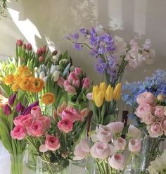 several vases filled with different types of flowers