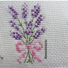 a cross stitch pattern with purple and pink flowers