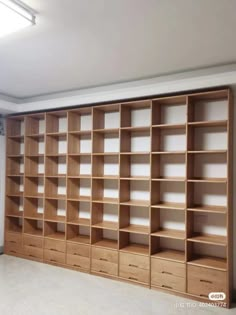 an empty room with many wooden shelves in it