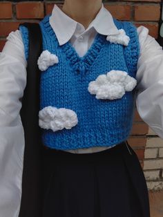 a person wearing a blue vest with clouds on it