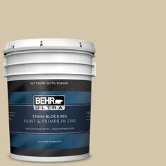 a bucket of behr premium ultra paint and primer in one on a pink background