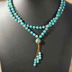 Authentic Turquoise Mala Necklace: 108 Beads for Peace & Tranquility Embrace inner peace and wisdom with this handcrafted turquoise mala necklace. Features: 108 genuine turquoise beads: Each bead hand-knotted for mindful meditation. Calming turquoise color: Evokes feelings of balance, peace, and inner strength. Durable nylon cord: Designed for long-lasting wear and comfort. Simple yet elegant beaded tassel: Adds a touch of tradition. Perfect for meditation, prayer, or everyday wear: Wear your in Turquoise Polished Beads Spiritual Necklaces, Turquoise Spiritual Beaded Necklaces With Polished Beads, Turquoise Gemstone Beads For Gift, Spiritual Turquoise Beaded Necklaces, Spiritual Turquoise Beaded Necklaces With Round Beads, Spiritual Turquoise Necklace With Round Beads For Healing, Spiritual Turquoise Beaded Necklaces With Gemstone Beads, Spiritual Turquoise Gemstone Beaded Necklaces, Adjustable Turquoise Jewelry With 108 Beads