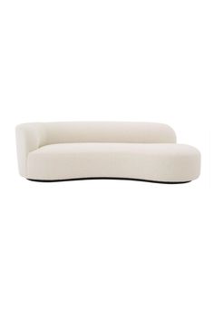 a white couch sitting on top of a white floor