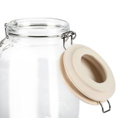 a glass jar with a plastic lid and a metal clip