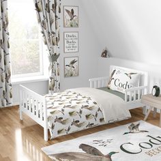 a child's bedroom with white bedding, curtains and bird prints on the walls