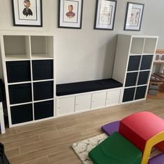 a living room filled with lots of furniture and pictures on the wall above it's bookshelves