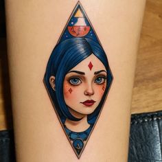 a woman's face with an upside down triangle tattoo on her thigh, and the image of a space ship in the background