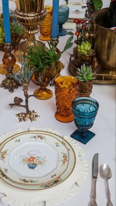 a table topped with lots of different types of plates and bowls filled with plants on top of it