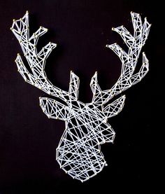 a string art deer head on a black background with white strings attached to it's antlers