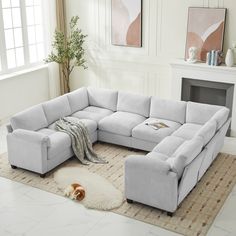 a living room with a sectional couch and rug on the floor next to a fireplace