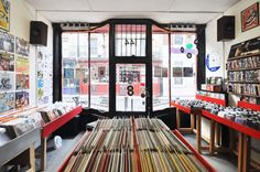 an old record store with records on the floor and in front of large glass windows