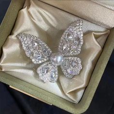 Embrace elegance with our Butterfly Brooch, featuring a radiant 8-9mm freshwater pearl nestled among sparkling cubic zirconia. Available in gold and silver finishes, this exquisite piece adds a touch of sophistication to any outfit. A perfect gift to symbolize transformation and beauty Material: Gold plated on brass, cubic zirconia, and freshwater pearls Pearl Size: 8-9mm Note: Our jewelry is handmade. Naturally formed shapes of freshwater baroque pearls may vary. The actual product may be sligh Diamond Round Brooch Gift, Silver Crystal Brooches As Gift, Silver Crystal Brooches For Gift, Elegant Pearl Brooches For Formal Occasions, Elegant Round Rhinestone Brooches, Elegant Round Brooches With Rhinestones, White Rhinestone Brooches For Formal Occasions, Round Diamond Accented Brooches For Gift, Round Brooches With Diamond Accents As A Gift