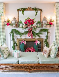 a living room decorated for christmas with green and pink decorations on the fireplace mantel