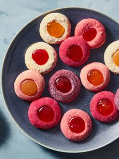 small pastries on a plate with jams and jelly in the middle, ready to be eaten