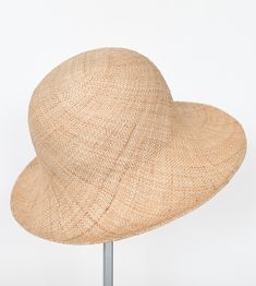 "\"Pina\" is a light summer sun hat with a wide flared brim. The shapely curve of the brim ensures a perfect fit and underlines a clear, feminine look. The material \"Bao\" made of the undyed fibres of the baobab tree is pleasantly permeable to air and ensures maximum wearing comfort. Available in sizes 55 cm - 60 cm. Colour \"nature\" Hat of \"Bao\" - Monkey bread tree Grosgrain ribbon (inside) made of 66% cotton and 34% polyamide Handmade Individualization options Other colours or sizes on req Chic Natural Color Bucket Hat, Chic Natural Bucket Hat, Chic Toquilla Straw Bucket Hat With Curved Brim, Beige Wide Brim Bucket Hat In Toquilla Straw, Beige Toquilla Straw Bucket Hat With Flat Brim, Beige Wide Brim Toquilla Straw Bucket Hat, Elegant Natural Fedora For Spring, Chic Beige Short Brim Bucket Hat, Elegant Natural Straw Sun Hat