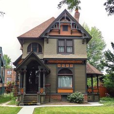 an old style house with brown shingles on the roof