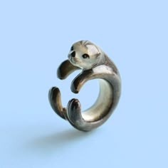 a silver ring with an animal on it's face and the letter c in the middle