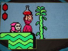 an image of a cross stitched bag with a cartoon character on the front and side