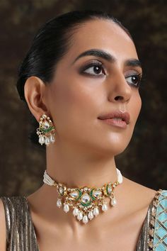 22k gold-plated choker with kundan encrusted pendant, multi- pearl strings and crescent moon motifs. Comes with danglers.
ComponentsNecklace, Pair of earrings
Type:Kundan, Stone, Pearl
Composition:Silver Alloy
Color:Gold
Multi-pearl strings
Pearl drops
Weight (gms): 110
Size (inch): Necklace: 14; Earrings: 1.75
Closure: Necklace: Adjustable drawchord; Earrings: Push back clasp - Aza Fashions Diamond Tufted Headboard, Pendant Choker Necklace, Pendant Choker, Choker Necklace Set, Bead Pendant, Jewelry Choker, Jewellery Set, 22k Gold, Beaded Pendant