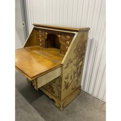 an old wooden desk with drawers on it