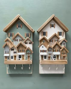 two wooden houses are hanging on the wall