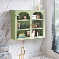 a bathroom with a sink and green cabinet