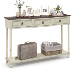 a white console table with two drawers and baskets