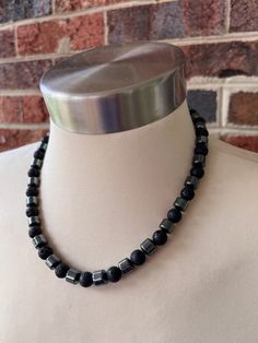 A medium weight beaded mens necklace made with lava rock and hematite beads. - Length is 19" (more lengths are listed)- Gunmetal lobster claw clasp (more options available)- 8mm beads - Heavy duty flexible nylon coated stainless steel beading wire To get the correct length, add at least 1.5"- 2" to your dress shirt neck size. This will give you a short choker fit with a little extra room. Otherwise choose a longer length. The mannequin's neck size is 14.5". A matching bracelet can be added to yo Beaded Necklace Designs For Men, Men Bead Necklace, Men Beaded Necklace Ideas, Men’s Beaded Necklace, Men Beaded Necklace, Male Jewellery, Beaded Necklace For Men, Mens Choker Necklace, Men Choker