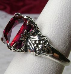 <> Made To Order This lovely sterling silver filigree ring is set with a lovely (approximately 3ct) Simulated/Man-made red/pink ruby gemstone. The square cut ruby is 10mm long by 10mm wide. The ring is 8mm of the finger. Notice the detailed design of the silver filigree setting and band. This is an exquisite rendition of a Gothic/Renaissance filigree ring... and is ready to wear. A white ring gift-box is included. Feel free to ask questions and thanks for looking at my auctions. Suggested Gothic Filigree, Red Gemstone Ring, Red Garnet Ring, Antique Filigree, Vintage Revival, Filigree Jewelry, Garnet Pendant, Vintage Gothic, Jewelry Antique