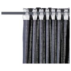 black and white curtains hanging on the side of a curtain rod with metal rods attached to it