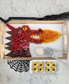 a tray filled with food on top of a white counter next to other foods and utensils