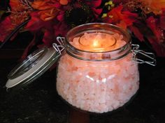 a glass jar filled with lots of pink beads