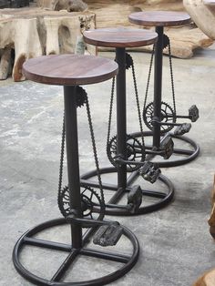 three metal and wood stools with chains on them