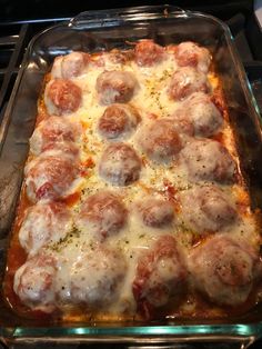 a casserole dish covered in meatballs and cheese