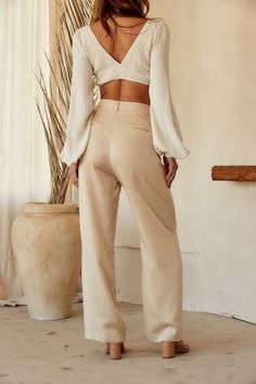 Your spring fit just got that much better thanks to the Jaxon Cream Trousers. Wear from work to happy hour, these pants are easily dressed up or down. Style with your favorite crop, our Isla Straw Fedora, a pair of strappy sandals, and you're set for the entire day! PRODUCT DESCRIPTION AND MATERIALS: - cream wide leg trousers - pleated - button closure - functional front pockets - non-functional welt back pockets - high waisted fit - finished hem - 100% lyocell - dry clean only SIZE RECOMMENDATI Chic Non-stretch Wide Leg Pants With Belt Loops, Spring Wide Leg Pants For Day Out, Trendy Tapered Leg Bottoms For Spring, Chic Straight Leg Bottoms For Spring, Versatile Tapered Leg Pants For Day Out, Trendy Spring Workwear Bottoms, Trendy Bottoms For Spring Workwear, Trendy Spring Bottoms For Workwear, Versatile Spring Workwear Pants