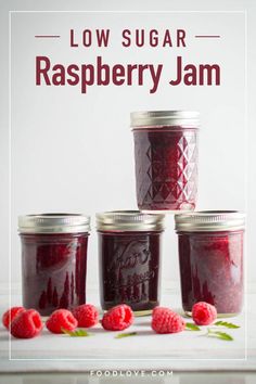 raspberry jam in jars with fresh raspberries on the side and text overlay reading low sugar raspberry jam