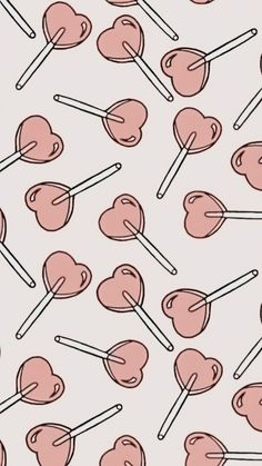 lollipops are arranged in the shape of hearts on a white background with pink and black lines