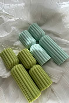 four soap bars sitting on top of a white sheet