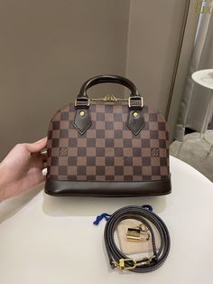 Louis Vuitton Alma BBDambier Ebene GHWSize 23 x 16 x 11 cmStrap drop 55 cmDate code AA31898-9/10 Great (handle glazing signs, corner rub and base imprints otherwise great)Includes box, dust bag, strap, key and lockRTP 2640 sgdPrice now 1500 sgd 1140 usd CN5832-01 Alma Bb Louis Vuitton, Lv Alma Bb, Lv Alma, Key And Lock, Expensive Things, Louis Vuitton Style, Alma Bb, Fashion 2024, Vuitton Bag