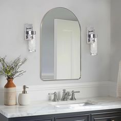 a bathroom vanity with two sinks and a large mirror