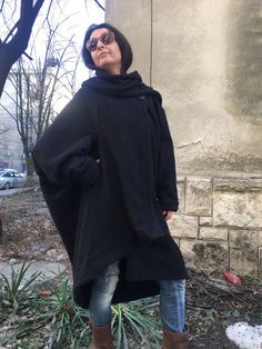 This is a cozy, effortless feel great coat. Oversized design, elegant shawl collar, long sleeves, asymmetric pointed hem.. One size fits all. Unlined.The fabric is wool machine knitting. Lenght at front 93cm/ 36"Lenght at back 124cm/ 49"For more beautiful designs, please visit and my new shop:https://www.etsy.com/shop/JustMariyaFromBG?ref=seller-platform-mcnav Oversized Winter Cape For Cold Weather, Cozy Oversized Cape With Long Sleeves, Oversized Cape Cardigan For Fall, Oversized Winter Cape For Work, Oversized Winter Outerwear For Layering, Cozy Long Sleeve Cape For Cold Weather, Oversized Outerwear For Winter Layering, Oversized Wool Cape Coat For Fall, Cozy Long-sleeve Winter Cape