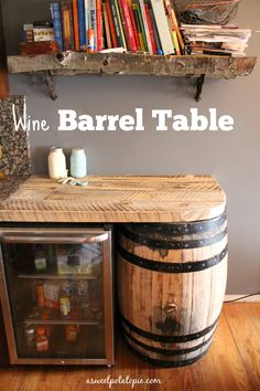 a wine barrel table sitting in front of a book shelf