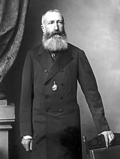 an old black and white photo of a man in a suit with a long beard