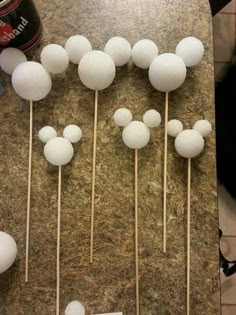 mickey mouse cake pops are arranged on a table