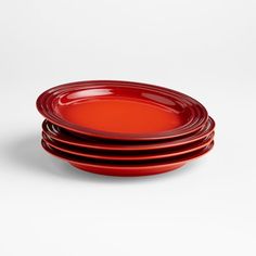 four red plates stacked on top of each other