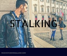 a man standing next to a woman in front of a building with the words stalking on it